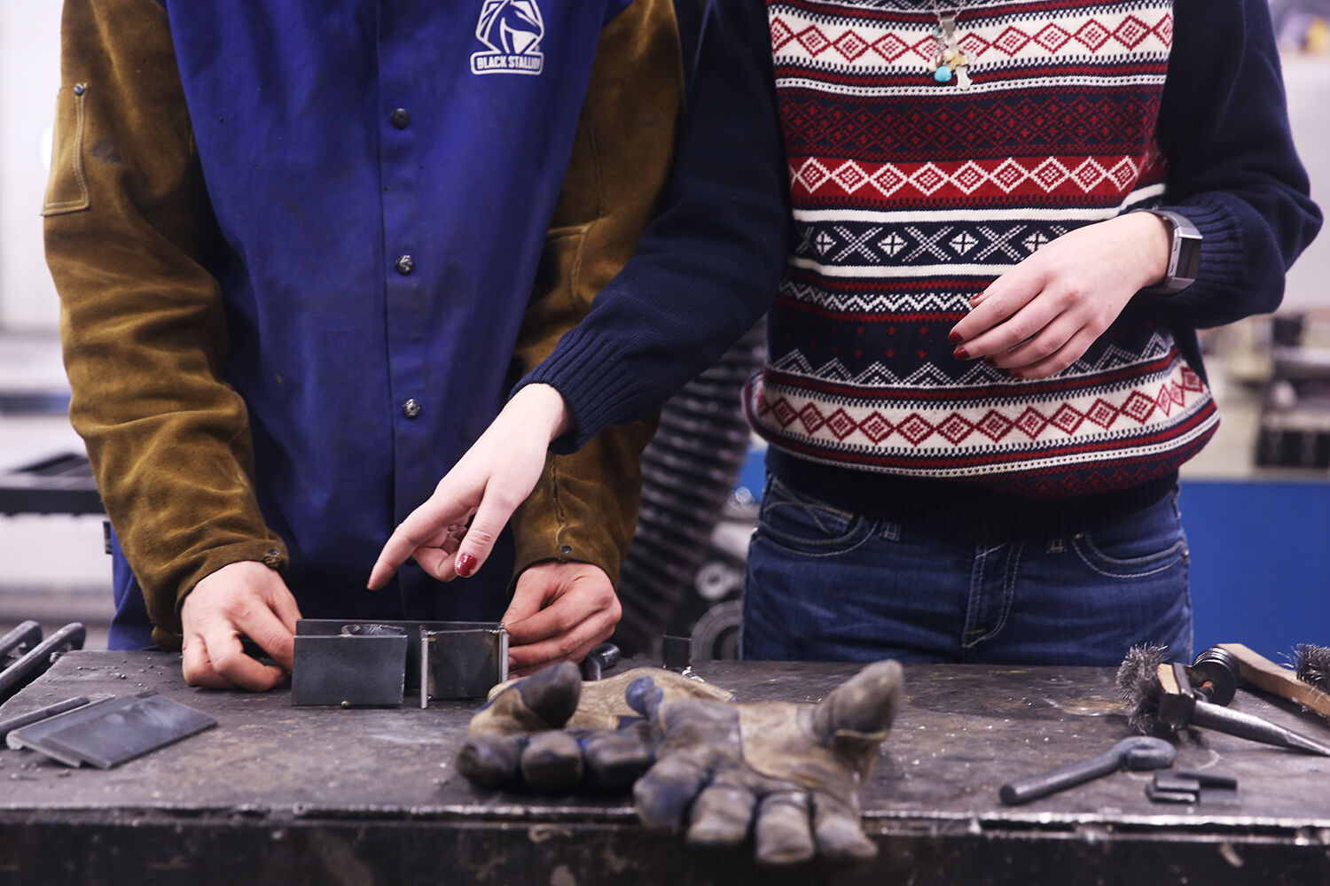 Teacher Taylor Rieniets, right, helps student Hutson Bowe